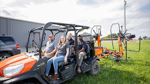 Students and professors sit in some of the new equipment for the agriculture department 