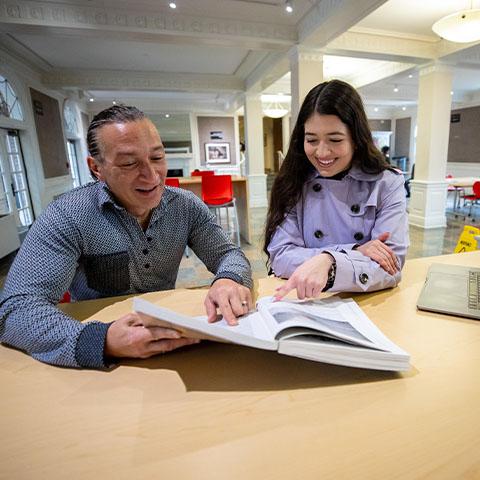 Spanish professor works with student 